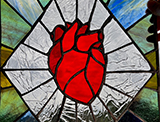 a heart surrounded with a burst, made from stained glass