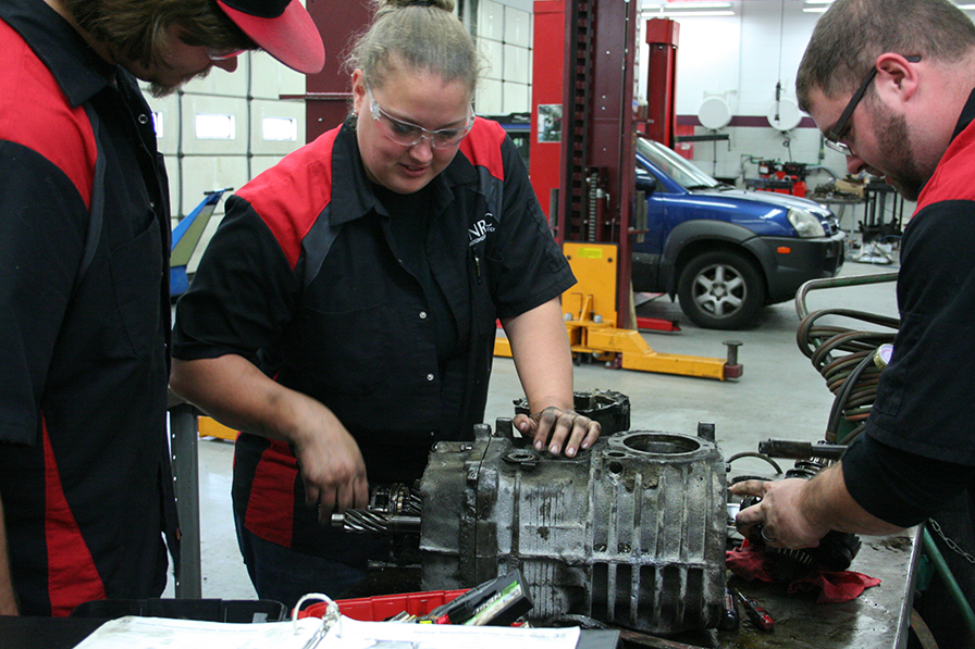 Students hand on to fix car parts
