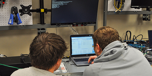 Two students working together at a computer